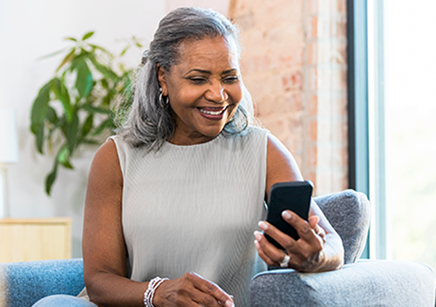 Women drinking coffee looking at phone